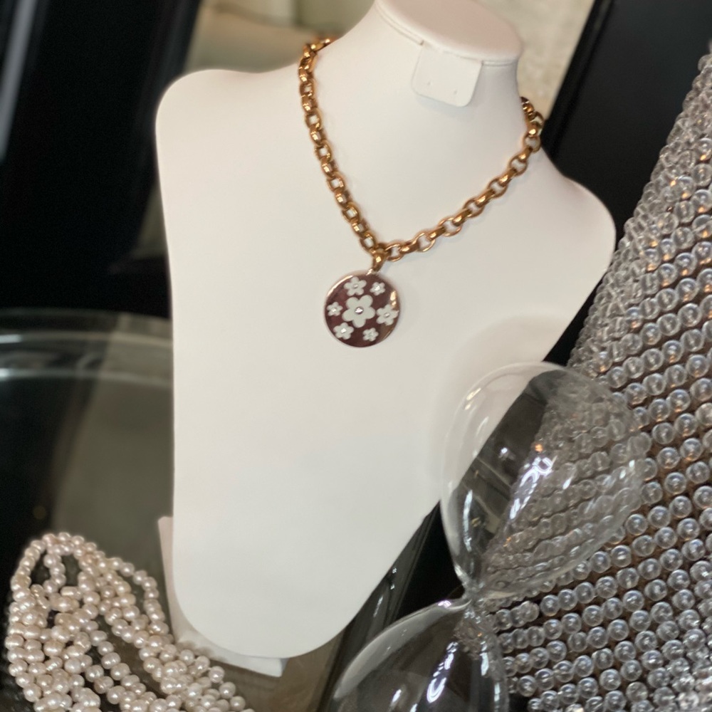 Gold tone necklace with flower white tones charm
